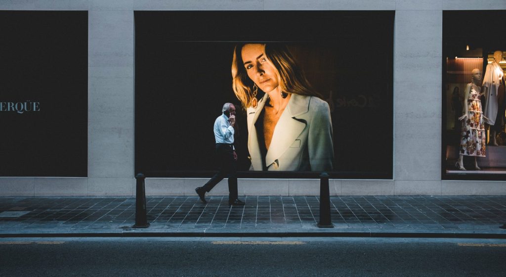 person walking near poster